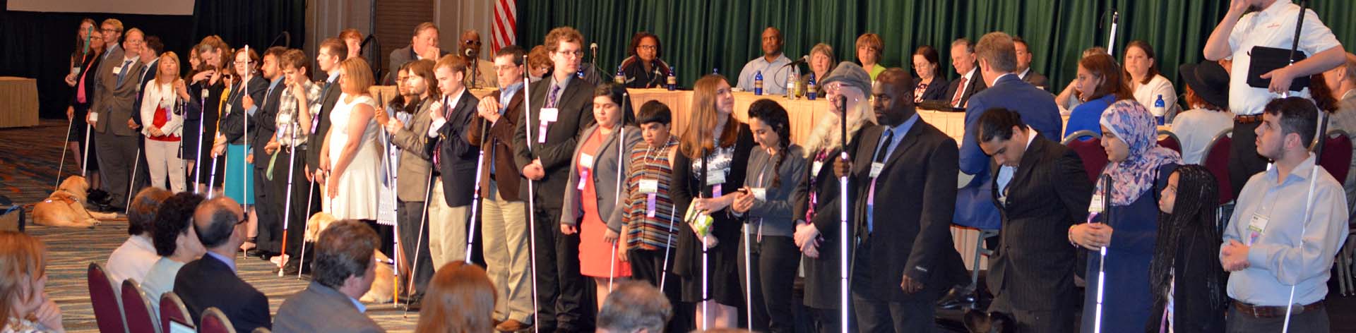 NFB scholarship winners line up in front of the convention to introduce themselves.